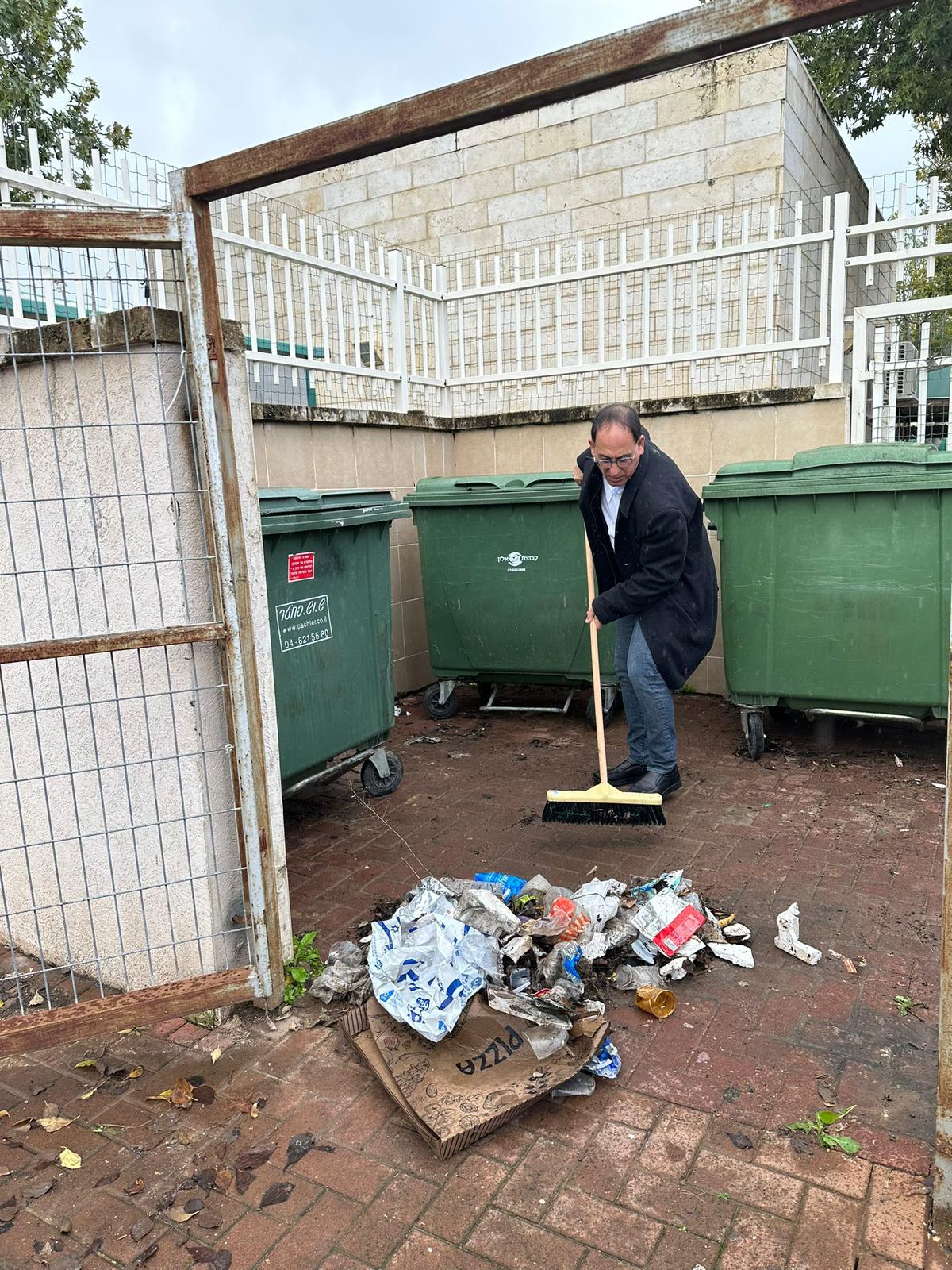 מנקים את העיר: זהר בלום ואבי קינד יצאו בגשם שוטף לנקות את הכניסה לאשכול גני ילדים